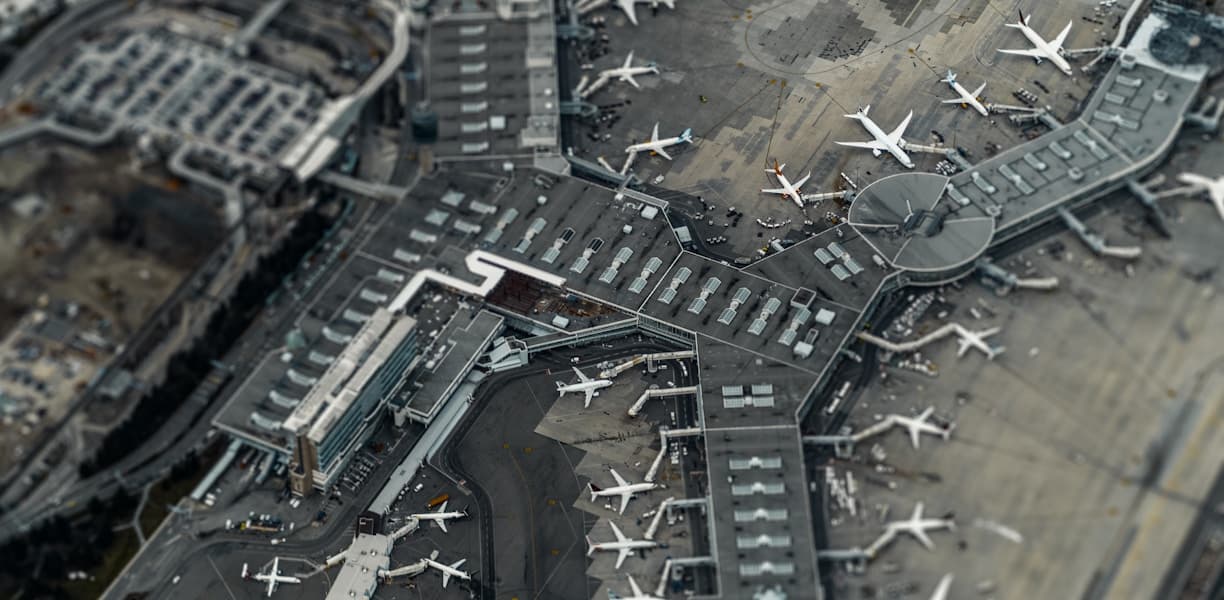 Aerial view of an airport terminal with aircraft parked at gates