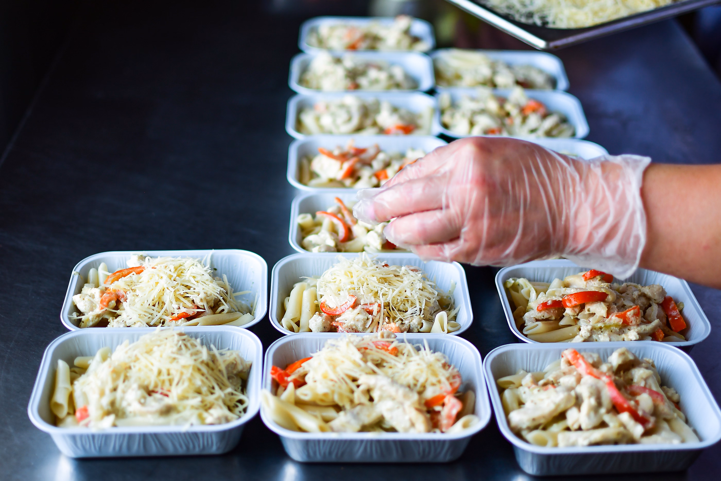 Meal trays being finished on a production line.